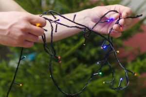 Checking Christmas lights before decorating this holiday